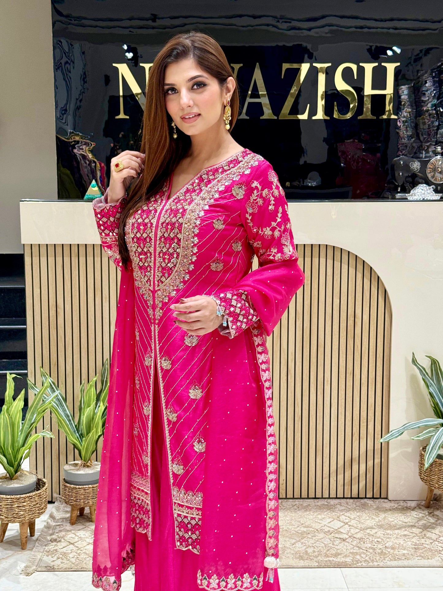 Elegant hot pink bridal Sharara set with handcrafted detailing on raw silk fabric, perfect for weddings and celebrations.