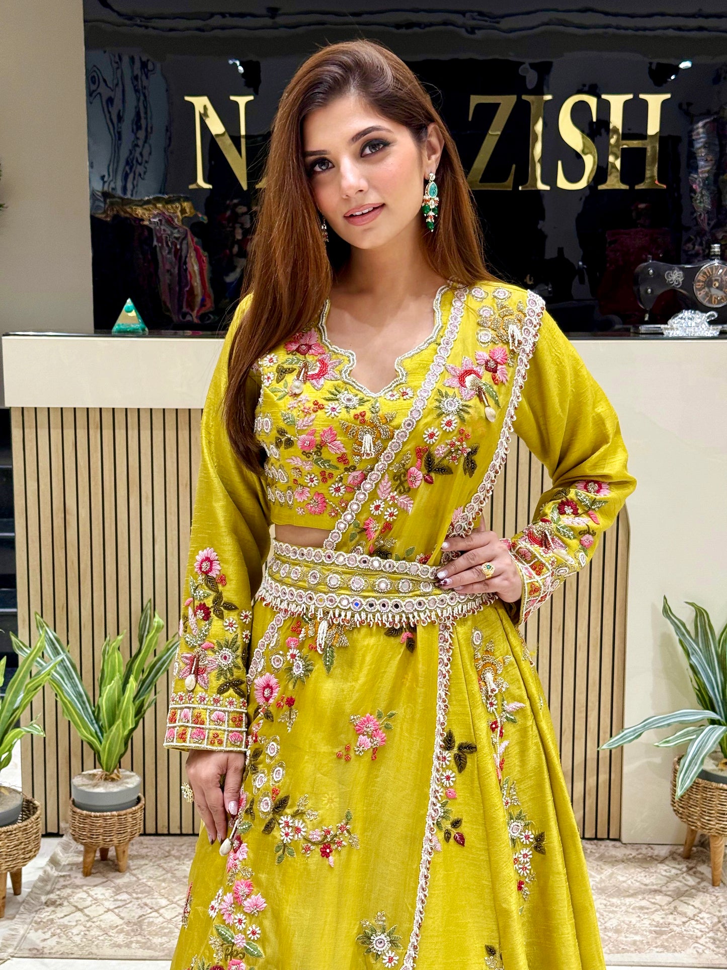 Vibrant neon lehenga crafted in raw silk with hand embellishments, featuring a fitted crop top, flared skirt, stylish dupatta drape, and embellished belt.