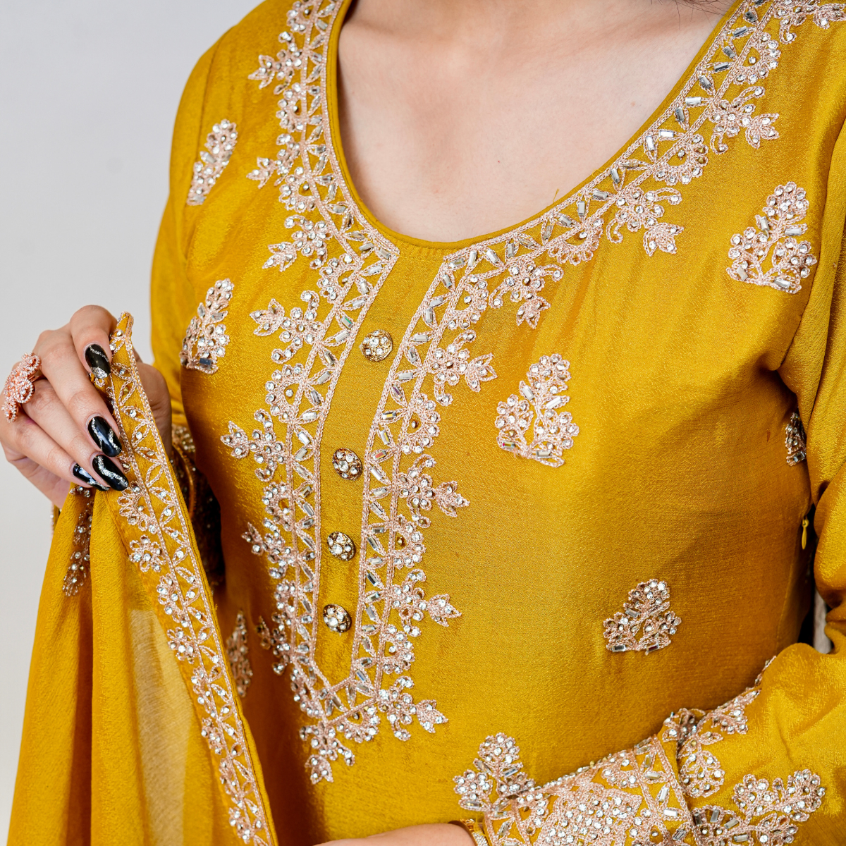 Bright, bold, and beautifully embellished—this mustard Sharara suit is a celebration of tradition and couture craftsmanship. Designed for festive occasions, weddings, and pre-wedding functions, it pairs timeless embroidery with a rich, vibrant hue. A true Nawazish classic.