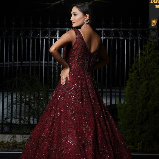 This maroon gown is a true representation of Nawazish's signature style—handcrafted couture with unmatched attention to detail. Featuring layers of embellishment and a flawless silhouette, it’s ideal for brides who want to feel bold, beautiful, and bridal in a modern yet traditional way.