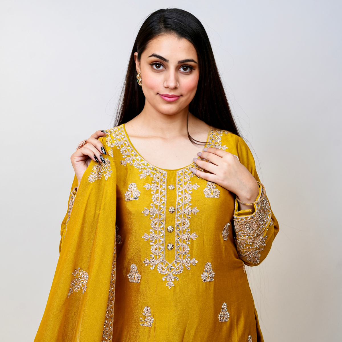 Bright, bold, and beautifully embellished—this mustard Sharara suit is a celebration of tradition and couture craftsmanship. Designed for festive occasions, weddings, and pre-wedding functions, it pairs timeless embroidery with a rich, vibrant hue. A true Nawazish classic.