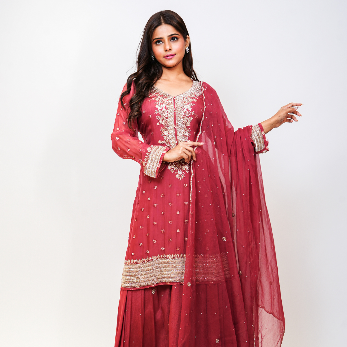 Elevate your ethnic wardrobe with Nawazish’s signature rose pink Sharara suit, handcrafted in rich fabric with all-over embellishment and a beautifully detailed neckline. The flowing sharara adds a festive flair, while the embroidery lends timeless charm. Ideal for the bride’s sister, bridesmaids, or anyone looking for elegant occasion-wear with artisanal appeal.