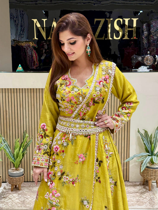 Statement neon lehenga outfit with detailed hand embroidery, full sleeves, a draped dupatta, and an ornate belt – ideal for modern brides or festive wear.