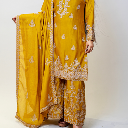 Bright, bold, and beautifully embellished—this mustard Sharara suit is a celebration of tradition and couture craftsmanship. Designed for festive occasions, weddings, and pre-wedding functions, it pairs timeless embroidery with a rich, vibrant hue. A true Nawazish classic.

