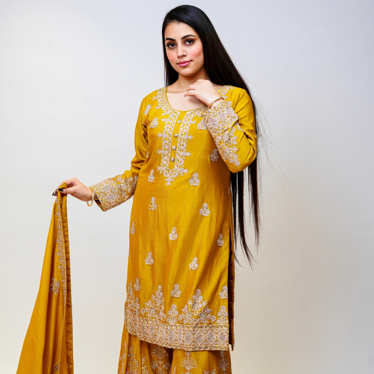 Bright, bold, and beautifully embellished—this mustard Sharara suit is a celebration of tradition and couture craftsmanship. Designed for festive occasions, weddings, and pre-wedding functions, it pairs timeless embroidery with a rich, vibrant hue. A true Nawazish classic.

