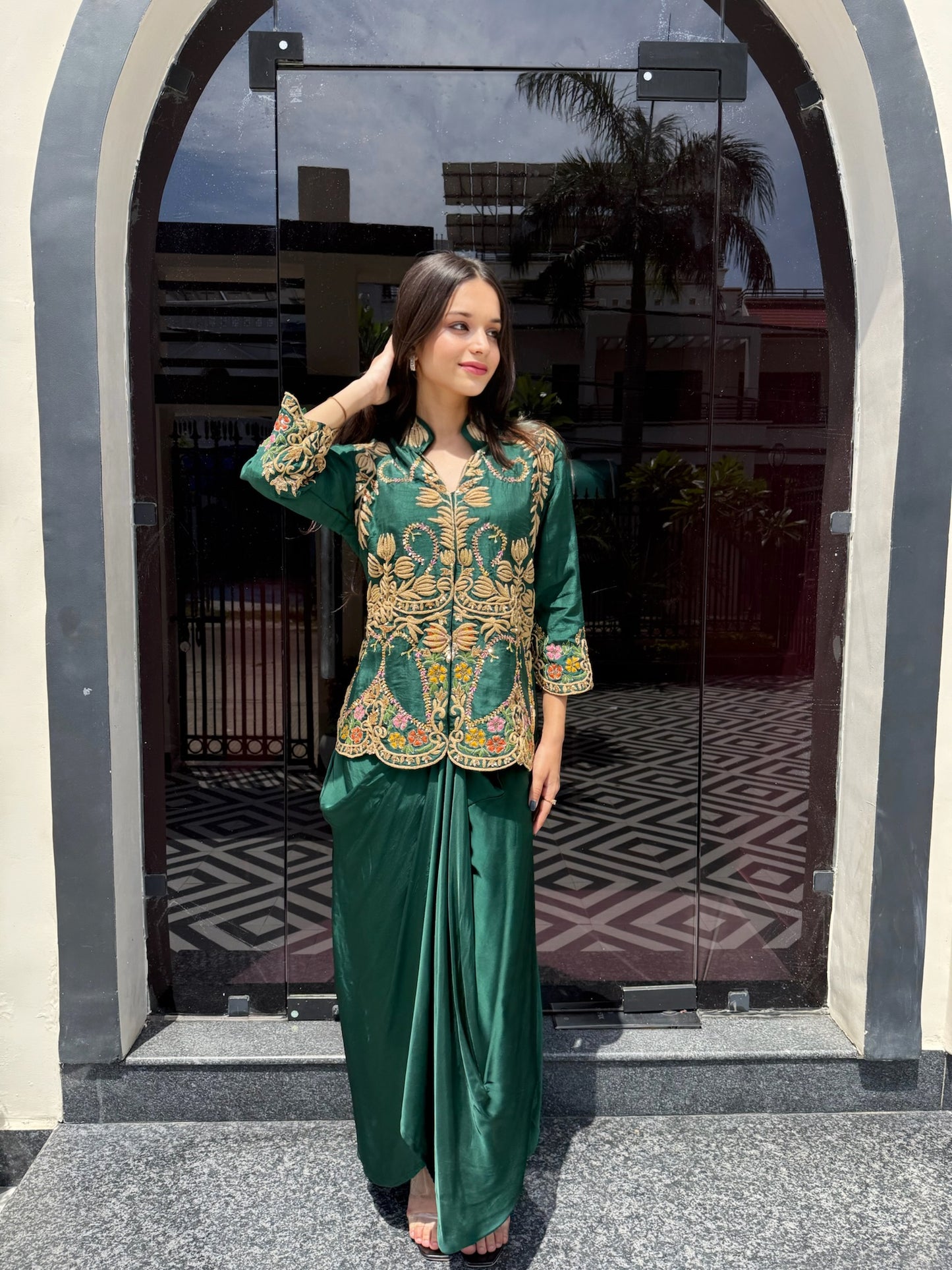 Crafted for statement dressing, this green co-ord set features a hand-embellished shirt with detailed threadwork and a flowing crêpe drape skirt—perfect for modern occasions.