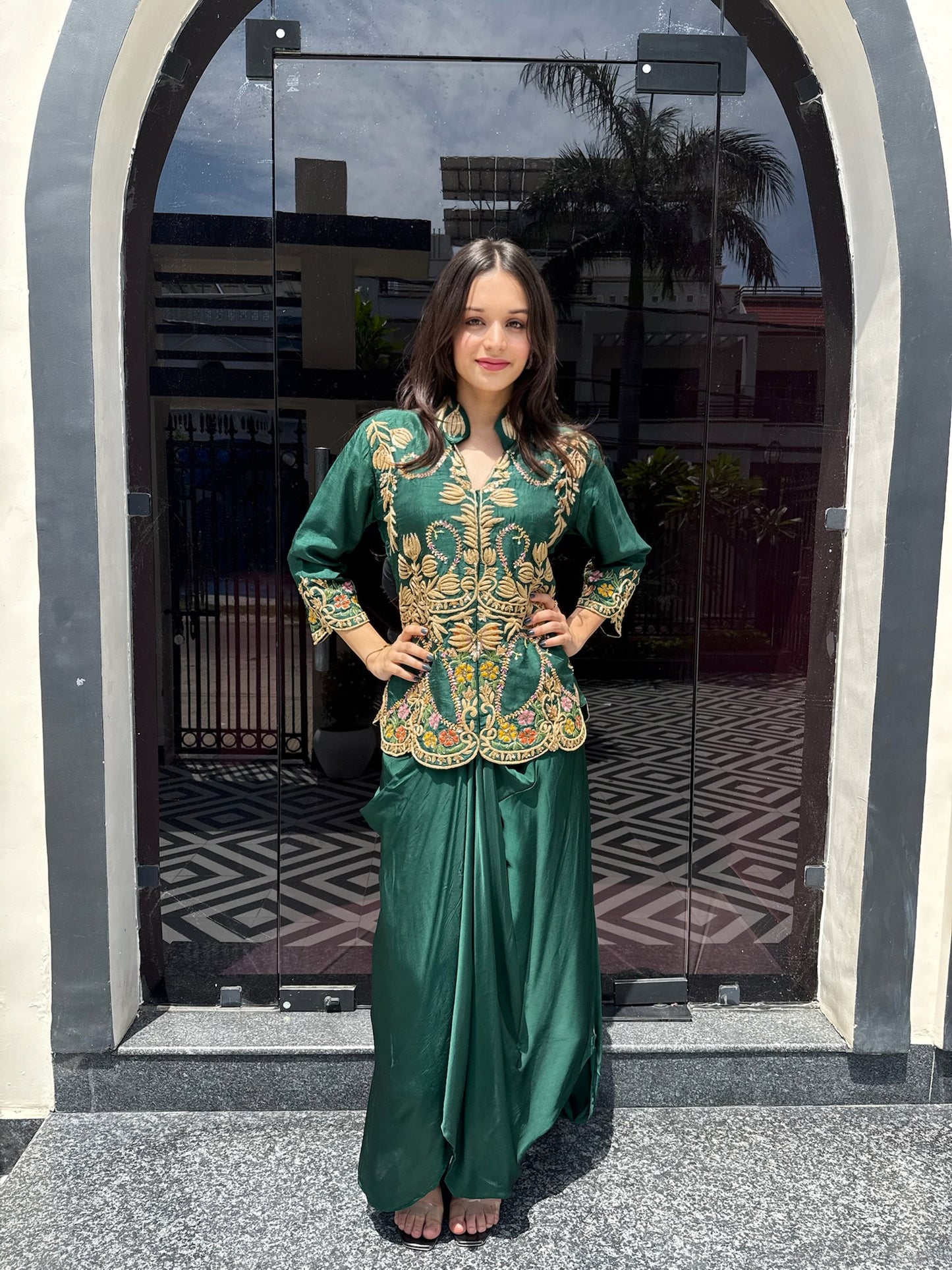 An elevated emerald shirt and drape skirt set, showcasing fine threadwork detailing on the shirt and a lightweight crêpe skirt for a sleek, contemporary silhouette.