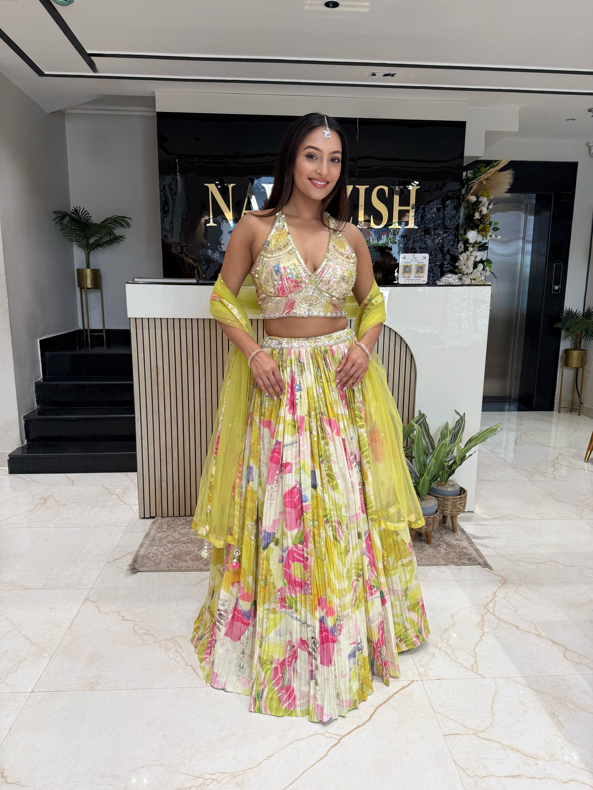 A vibrant haldi-ready lehenga in yellow tones, featuring intricate handwork and a soft organza cape, crafted for women who love lightweight luxury ethnic wear.