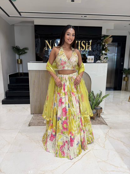 A vibrant haldi-ready lehenga in yellow tones, featuring intricate handwork and a soft organza cape, crafted for women who love lightweight luxury ethnic wear.