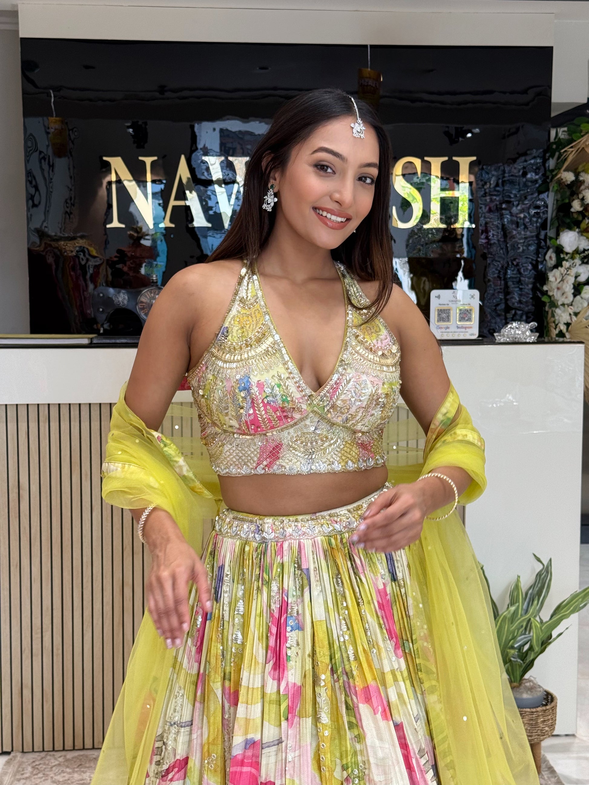 Elegant and breezy, this pleated floral lehenga set with embroidered blouse offers comfort, movement, and statement style for summer wedding functions.