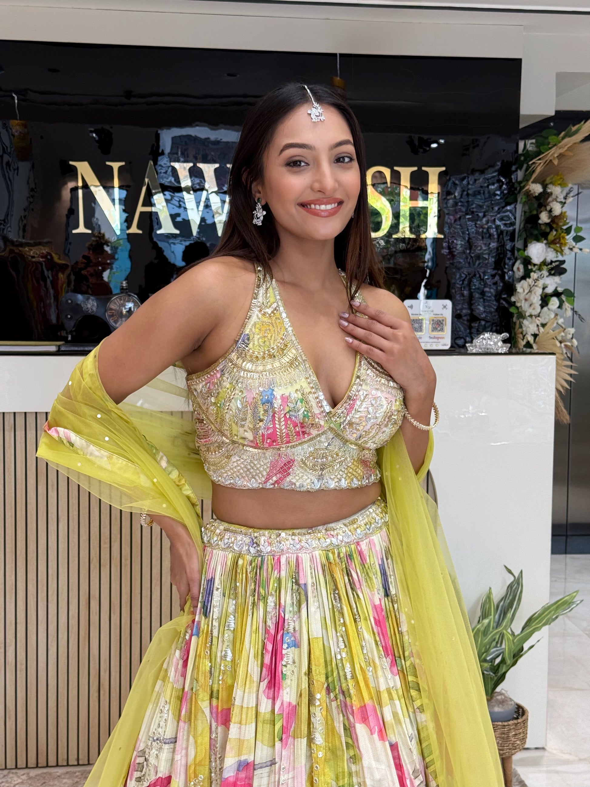A contemporary floral lehenga with cape-style dupatta, blending modern silhouettes with traditional craftsmanship—ideal for wedding guests and bridesmaids.