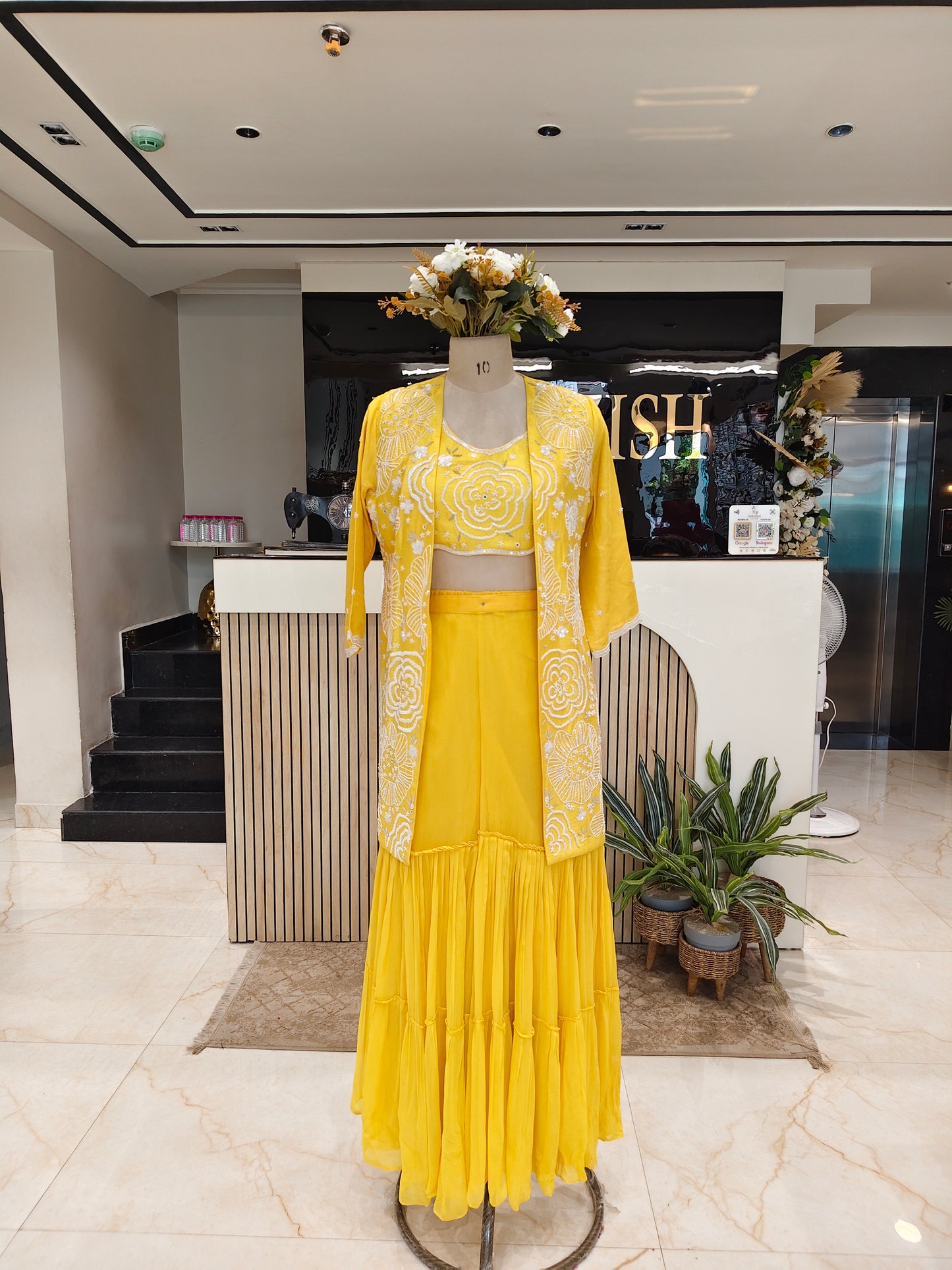 Yellow outfit on a mannequin in a stylish interior setting