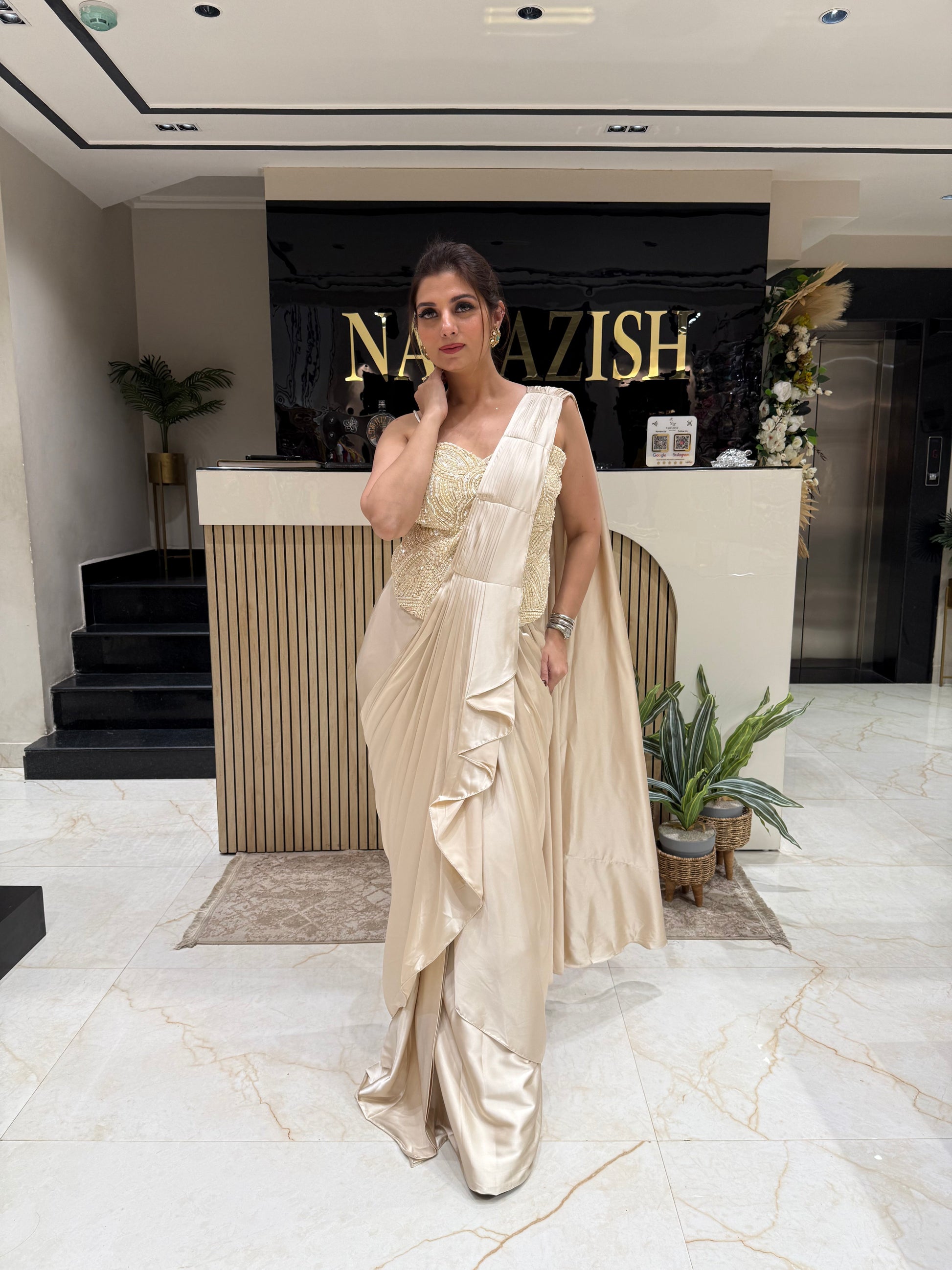 • Beige drape saree in satin with elegant frill design
• Stylish party wear drape saree with handwork cord set blouse
• Designer satin drape saree perfect for receptions and festive wear
• Glamorous ethnic wear for women with modern drape style
• Luxury beige drape saree for parties and wedding functions