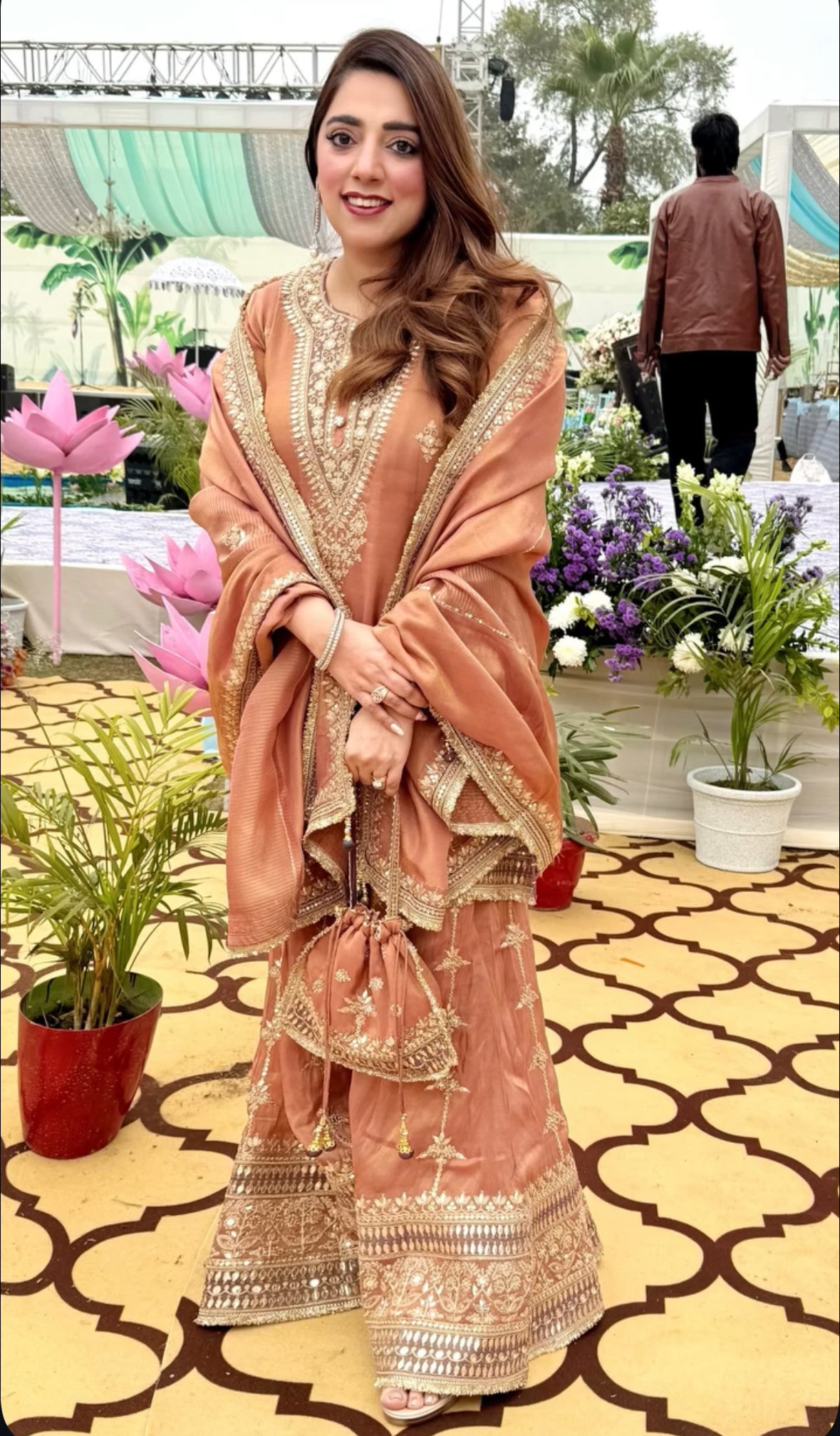 Effortless elegance meets handcrafted luxury in this stunning rose-gold Sharara suit from Nawazish. Made on delicate tissue fabric and richly hand-embellished with intricate detailing, this ready-to-wear ensemble is the perfect choice for weddings, receptions, or festive soirées.
At Nawazish, we bring together the beauty of couture craftsmanship and the ease of ready-to-wear fashion. This rose-gold Sharara suit is a timeless statement piece designed for the woman who values grace, shimmer, and sophistication—all without the wait.