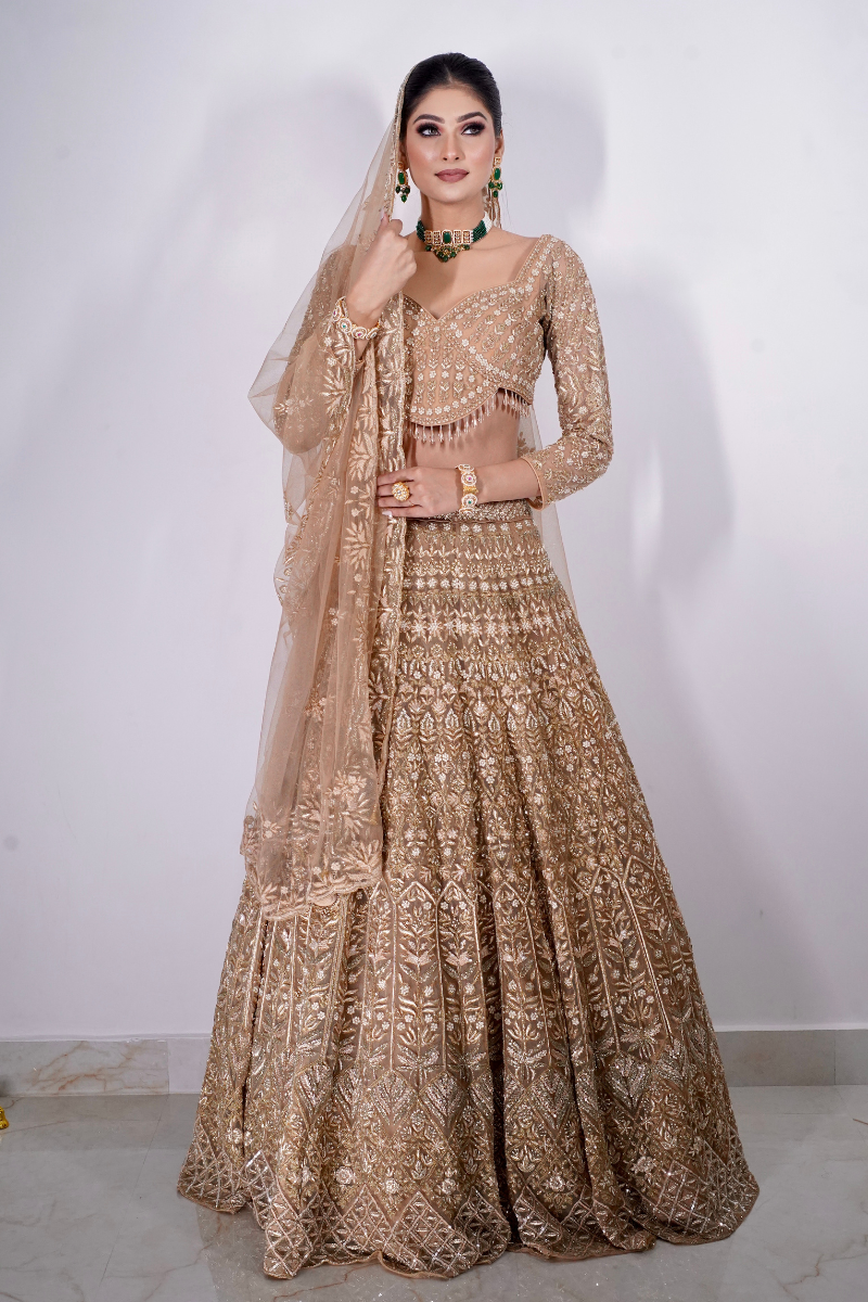 Step into royal elegance with Nawazish’s golden bridal lehenga, featuring the most beautiful and intricate hand embroidery. Crafted for the modern Indian bride, this designer masterpiece combines traditional craftsmanship with high-fashion design. Recognized as one of the best bridal lehengas in India, it’s the ultimate expression of luxury, heritage, and couture for your big day.
