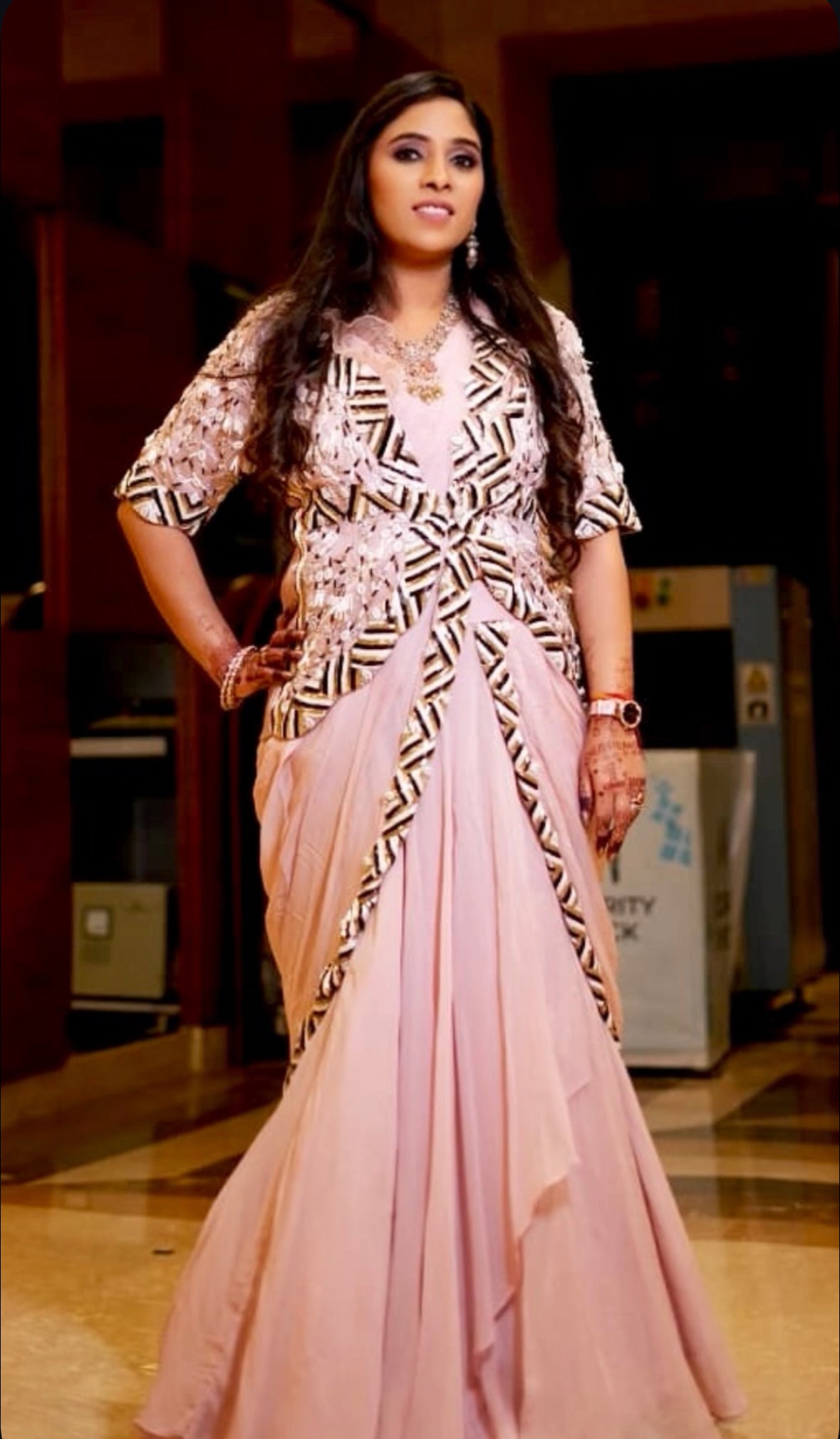 Make a statement in this show-stopping baby pink gown-style draped sari from Nawazish, paired with a heavily embellished jacket for a truly couture look. The soft, flowing silhouette meets high-fashion drama—perfect for cocktail nights, sangeet, or modern festive celebrations.
At Nawazish, we bring you the most stylish and trending outfits—from designer drapes to structured jackets—all handcrafted with intricate embellishments and statement detailing. For the woman who loves to stay ahead of the fashion curve, this is your moment.