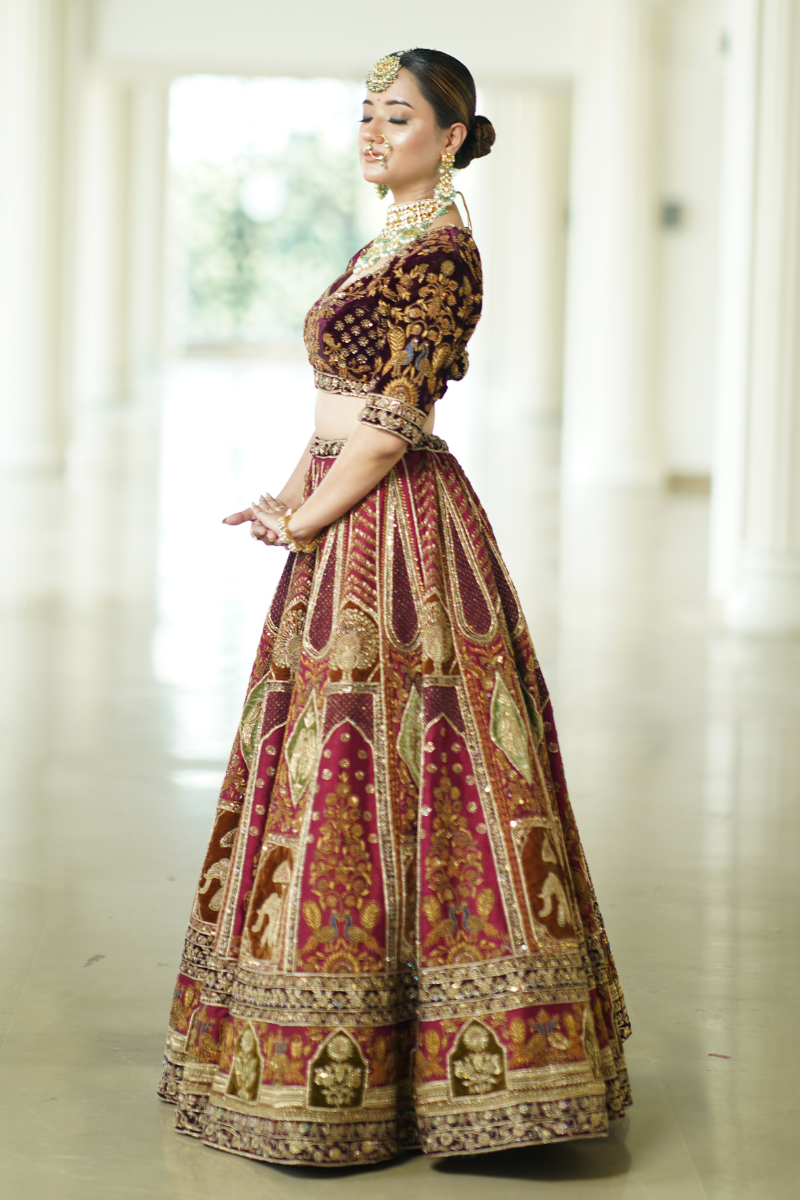 Experience regal elegance with Nawazish’s storytelling bridal lehenga, handcrafted on pure raw silk and paired with a rich velvet blouse. Adorned with exquisite Zardozi and Dabka hand embroidery, the lehenga showcases detailed Baraat procession motifs—blending timeless Indian heritage with couture luxury. A true heirloom piece for the bride who wants her wedding outfit to narrate a story of tradition and grandeur.